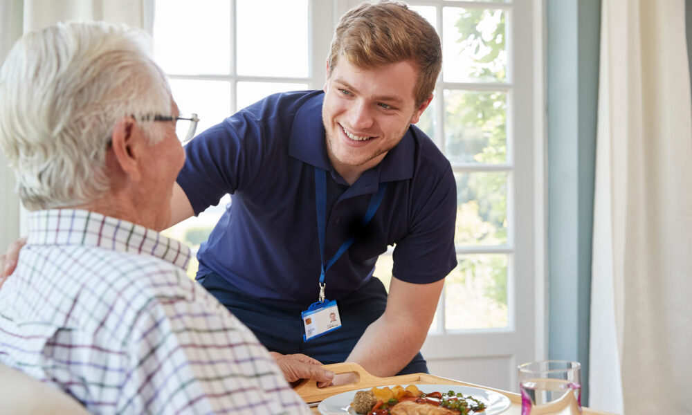 an NDIS registered social worker providing assistance to an elderly man