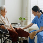 a NDIS registered physiotherapist providing assistance to an elderly woman on a wheelchair