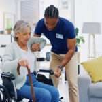 a male NDIS worker providing assistance to an elderly woman in a wheelchair
